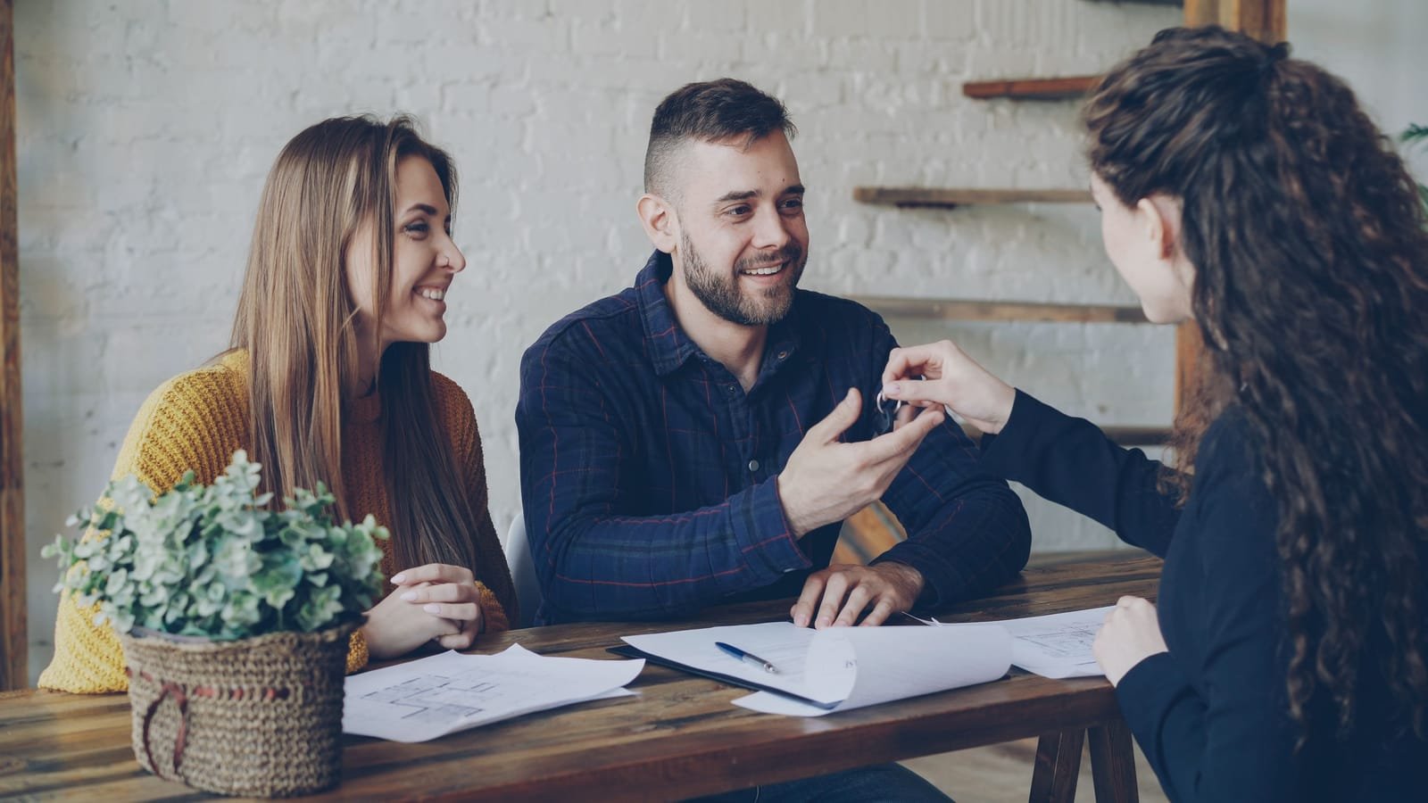 Mortgage advisor discussing financing options with clients.